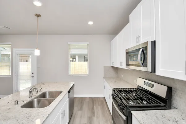 a kitchen that has a sink and a stove
