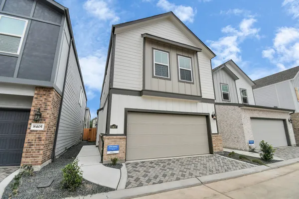 a front view of a house with garage