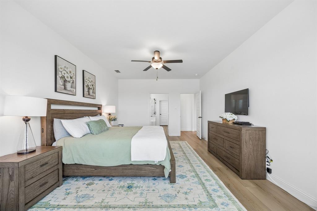 3200 Willowbrook Road Northlake, TX 76226 - Photo 15 of 29 Spacious room featuring wood-finish flooring, a ceiling fan, and bright white walls