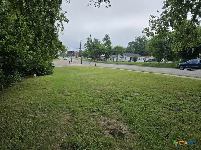 a view of outdoor space with garden and trees