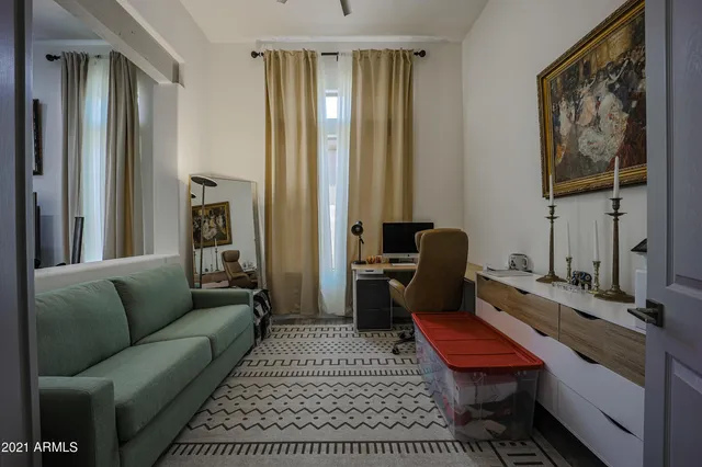 a living room with furniture a rug and a window