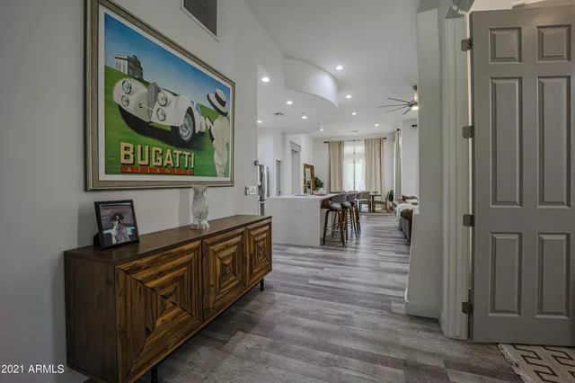 a view of a hallway with wooden floor and furniture
