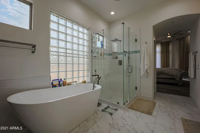 a bathroom with a bathtub and a shower