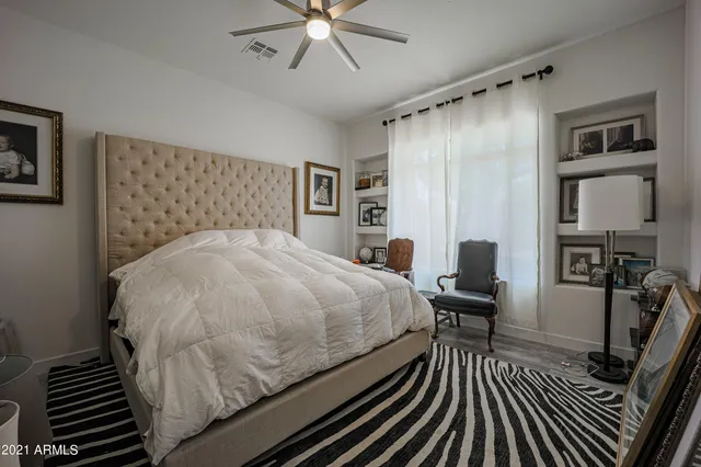 a bed sitting in a bedroom next to a window