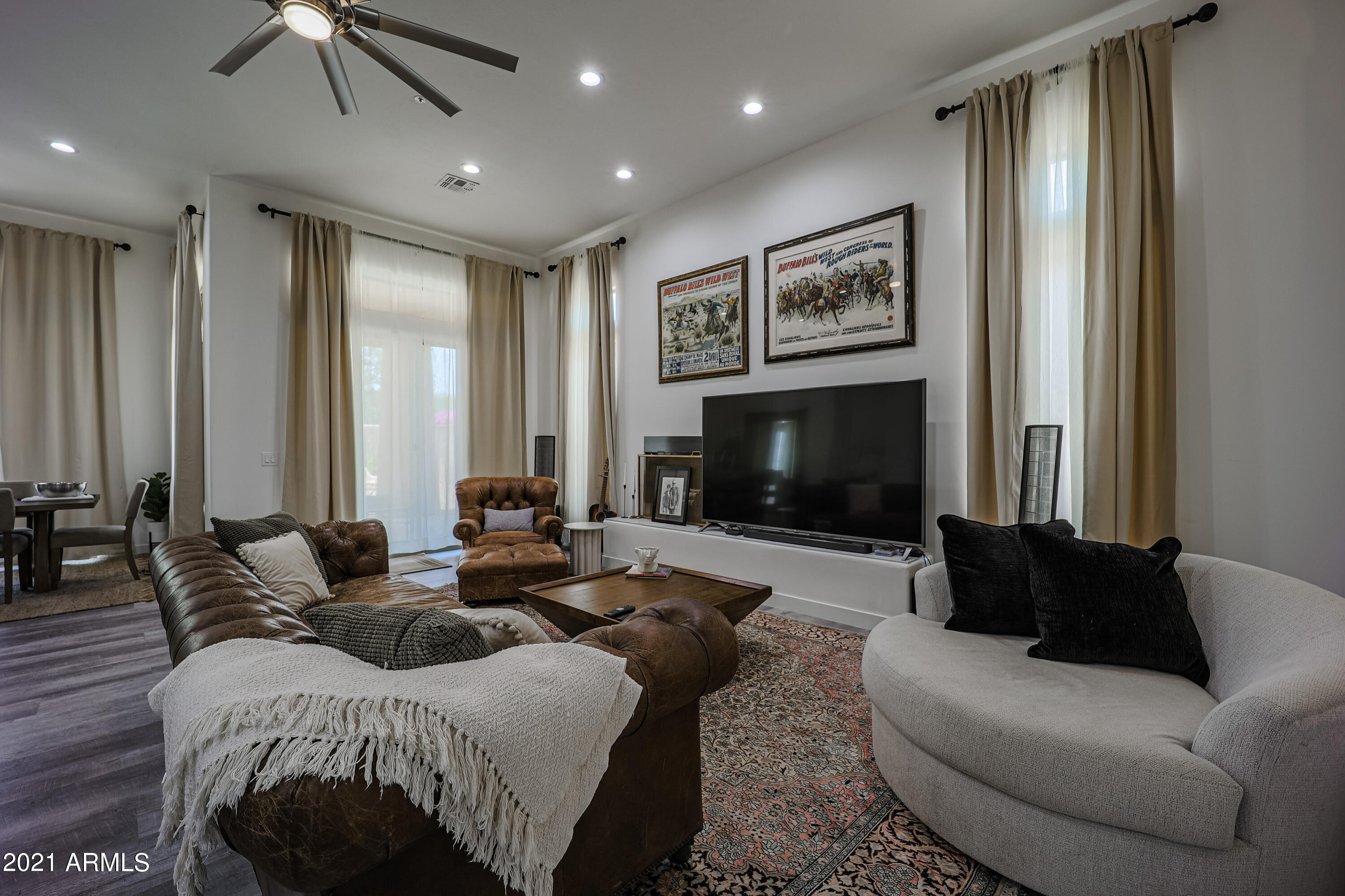 8136 East Beardsley Road Scottsdale, AZ 85255 - Photo 2 of 38 a living room with furniture a large window and a fireplace