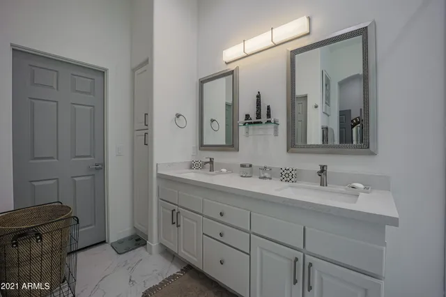 a bathroom with double sink and mirror