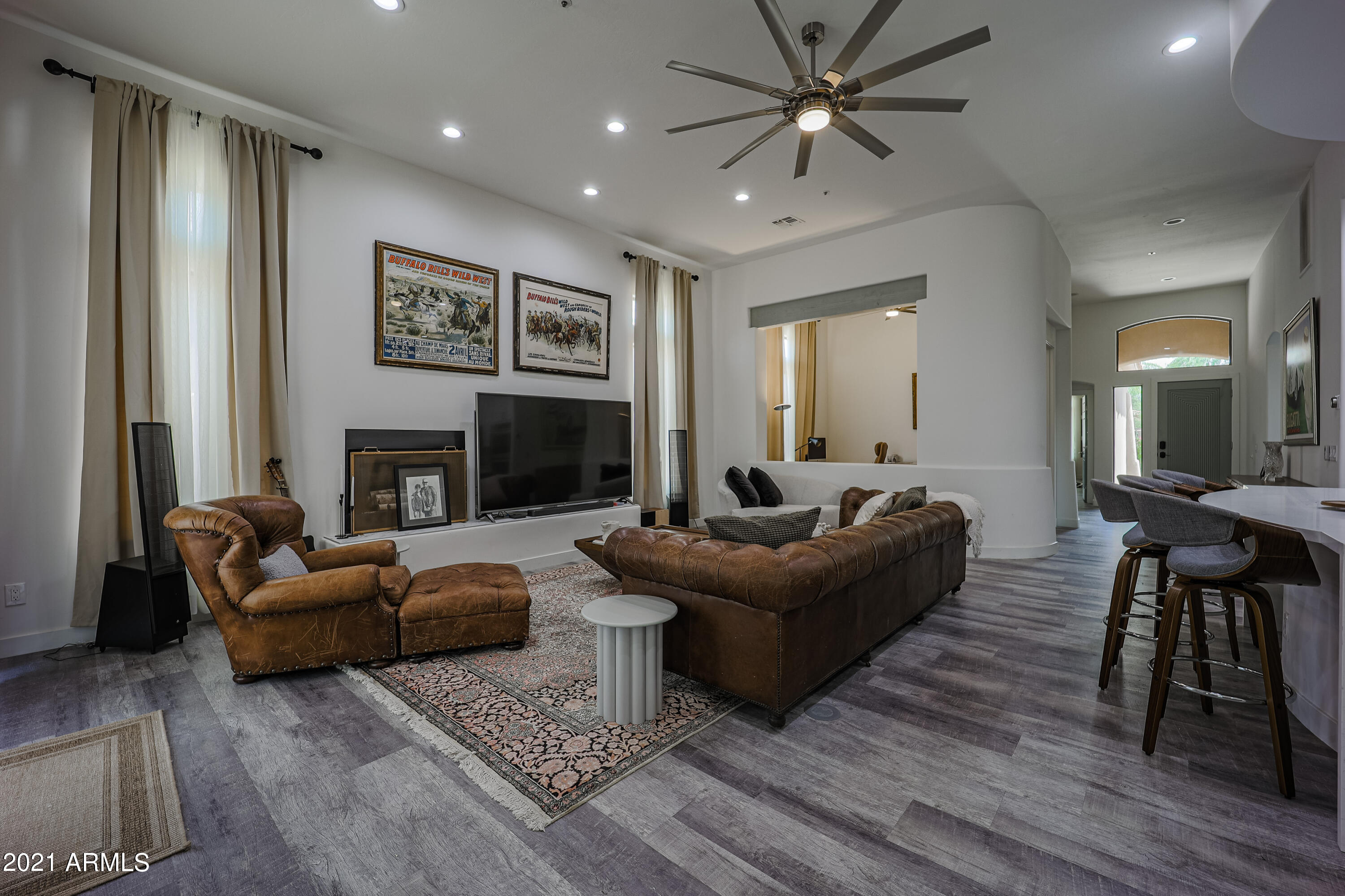 8136 East Beardsley Road Scottsdale, AZ 85255 - Photo 3 of 38 a living room with furniture a fireplace and a flat screen tv