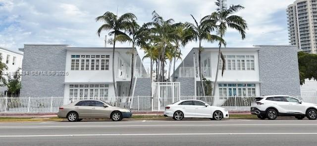 7445 Harding Avenue, Unit 110 Miami Beach, FL 33141 - Photo 1 of 19 a view of cars parked in front of a building