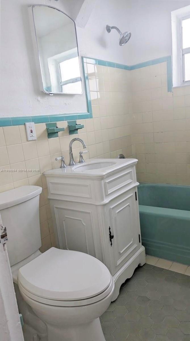 7445 Harding Avenue, Unit 110 Miami Beach, FL 33141 - Photo 11 of 19 a bathroom with a sink toilet and a mirror