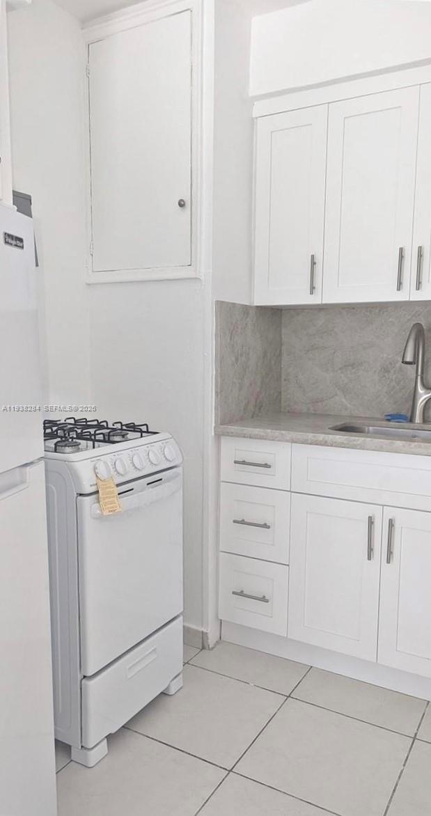 7445 Harding Avenue, Unit 110 Miami Beach, FL 33141 - Photo 6 of 19 a utility room with cabinets washer and dryer