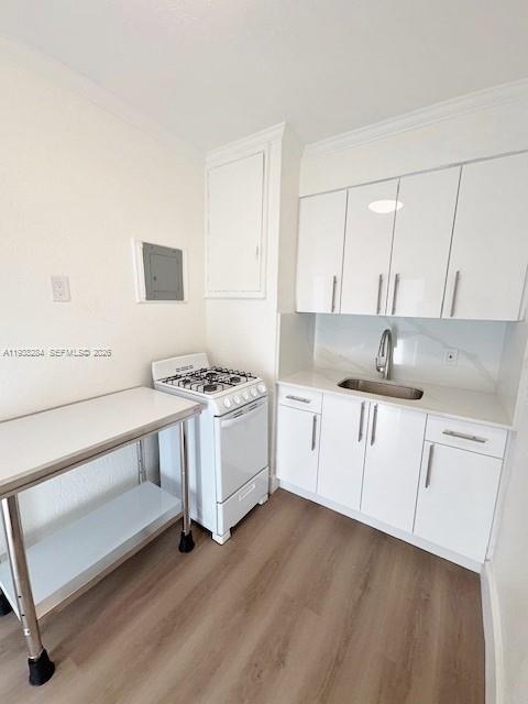 7445 Harding Avenue, Unit 110 Miami Beach, FL 33141 - Photo 7 of 19 a kitchen with granite countertop white cabinets and white appliances