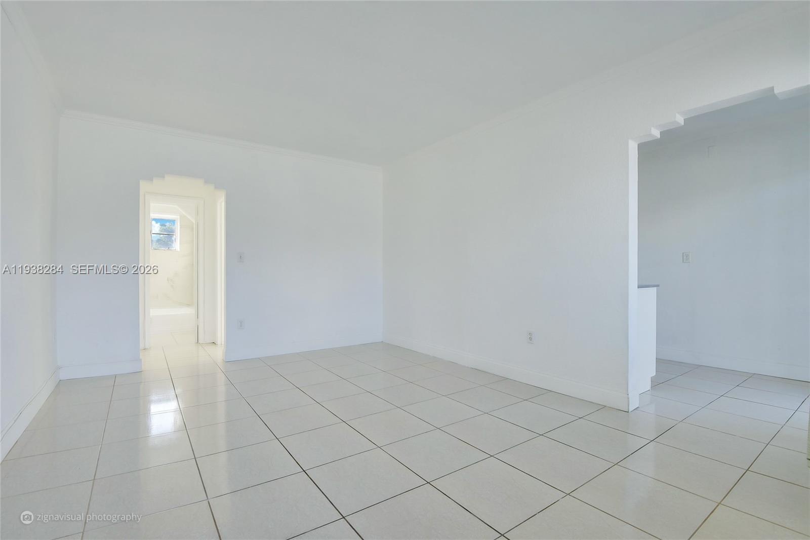 7445 Harding Avenue, Unit 110 Miami Beach, FL 33141 - Photo 9 of 19 an empty room with white door