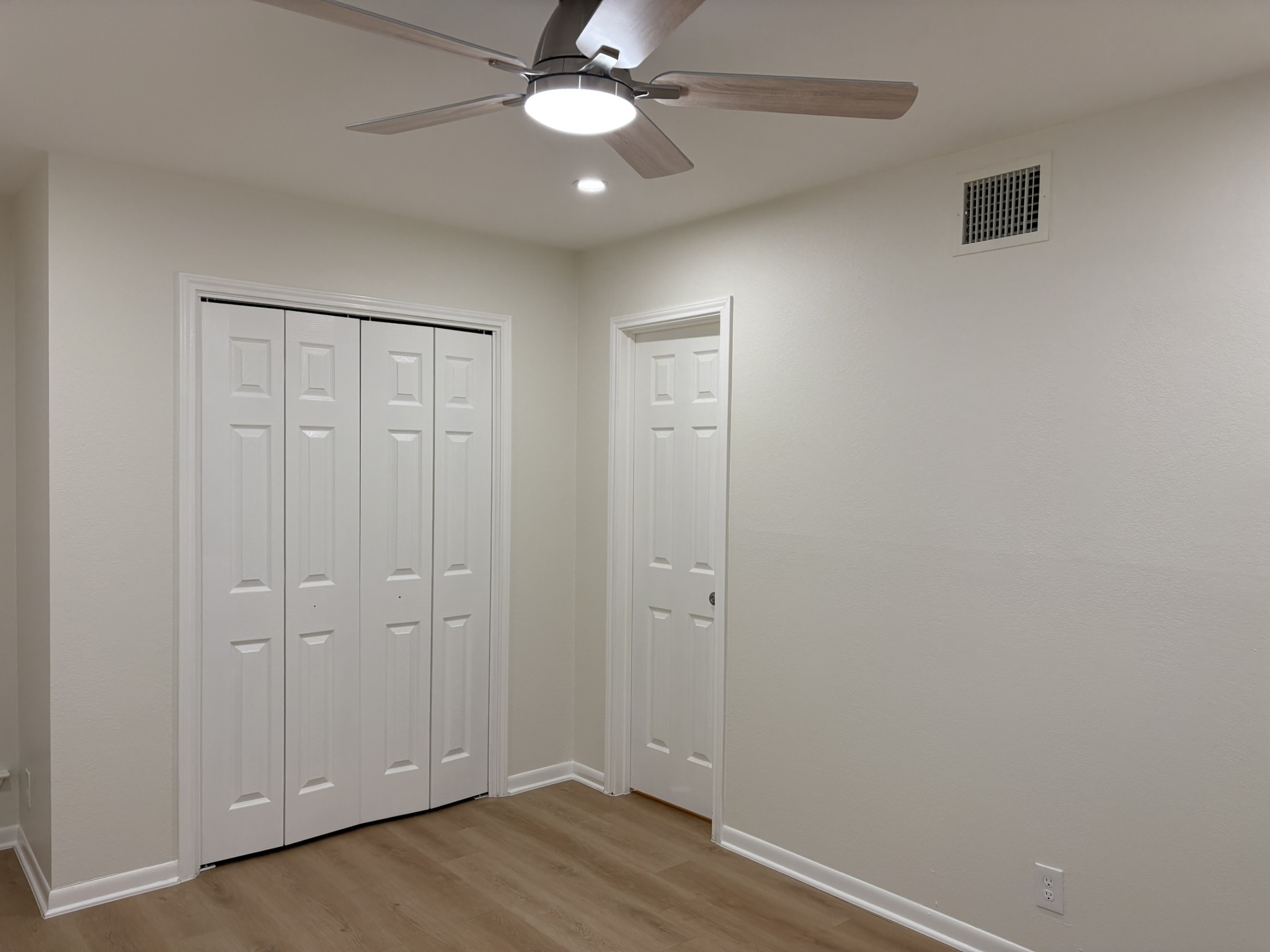 6009 Shadow Valley Cove, Unit A Austin, TX 78731 - Photo 11 of 24 Unfurnished bedroom with light wood-style floors, a ceiling fan, a closet, and recessed lighting