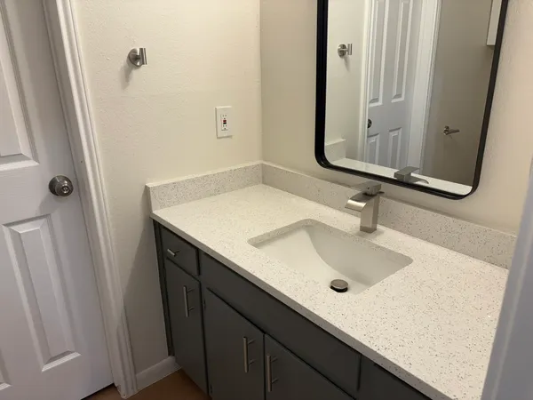 a white toilet sitting next to a sink
