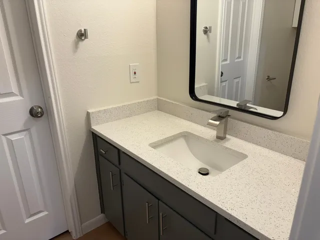 a white toilet sitting next to a white sink