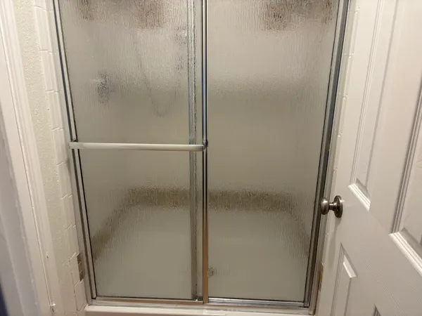 an empty room with a window and wooden floor