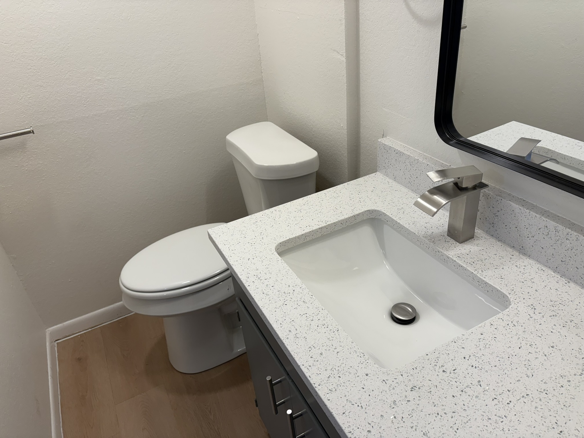 6009 Shadow Valley Cove, Unit A Austin, TX 78731 - Photo 20 of 24 Bathroom featuring vanity, dark wood-style floors, and a textured wall