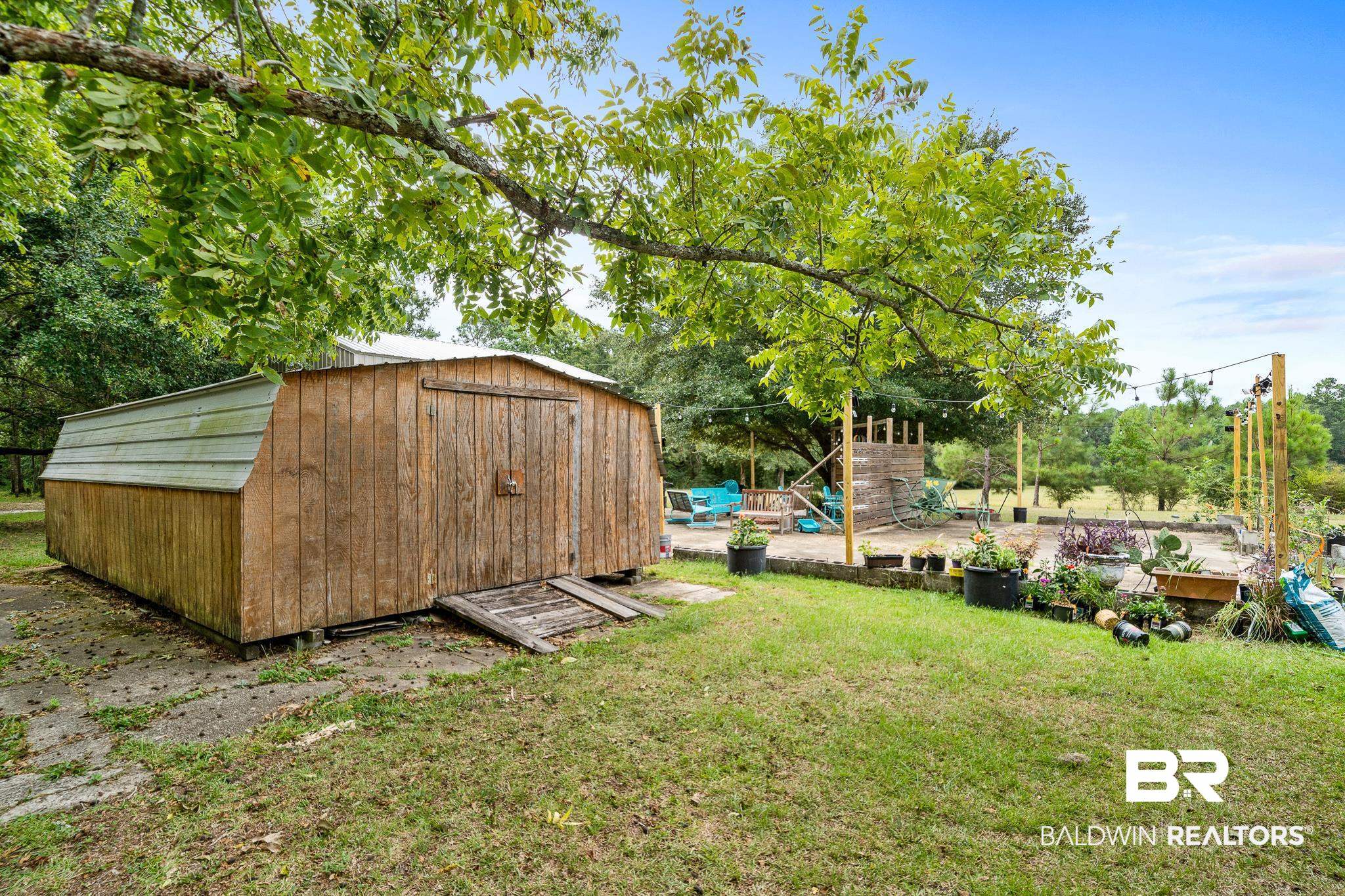 11528 Whitehouse Fork Road Bay Minette, AL 36507 - Photo 28 of 37 View of yard with a playground and a storage shed