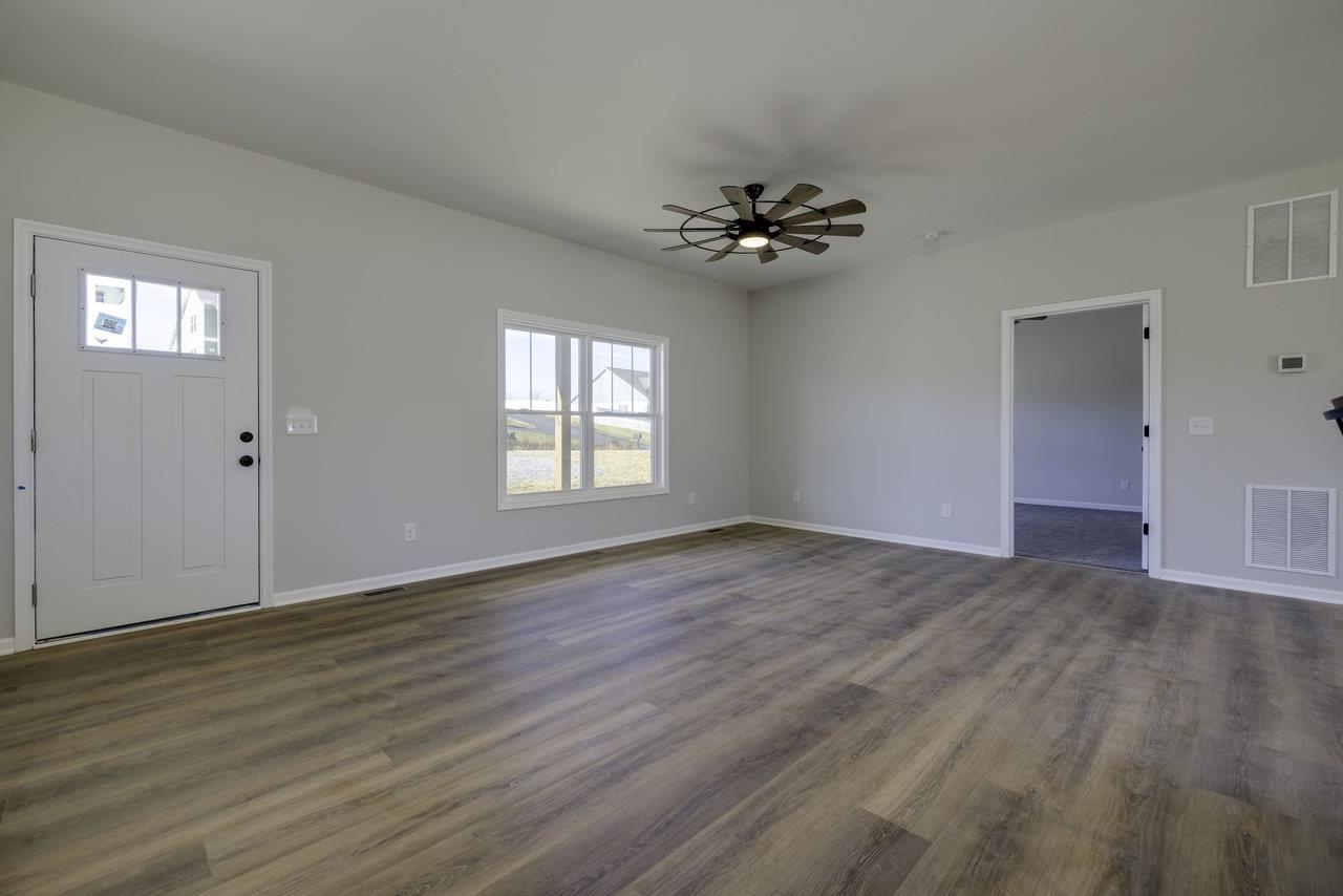 105 Springridge Lane Fairfield, VA 24435 - Photo 23 of 54 a view of an empty room with a window and wooden floor