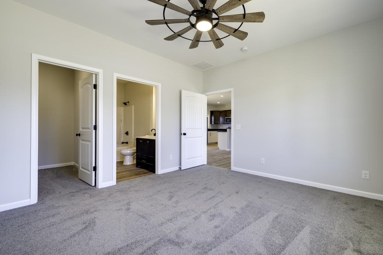 105 Springridge Lane Fairfield, VA 24435 - Photo 28 of 54 an empty room with chandelier fan and kitchen view
