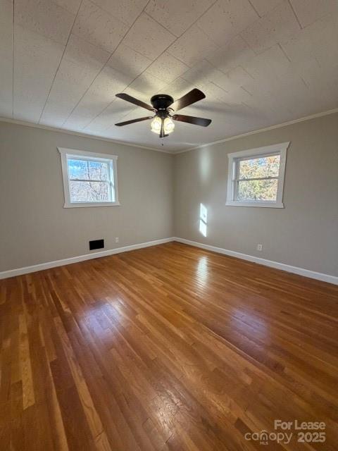 1972 Connelly Springs Road Lenoir, NC 28645 - Photo 11 of 13 a view of a room with wooden floor and a ceiling fan
