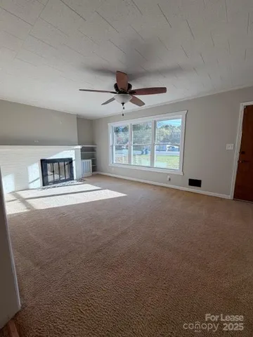 a living room with furniture and a ceiling fan