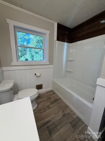 a bathroom with a toilet a sink and bathtub