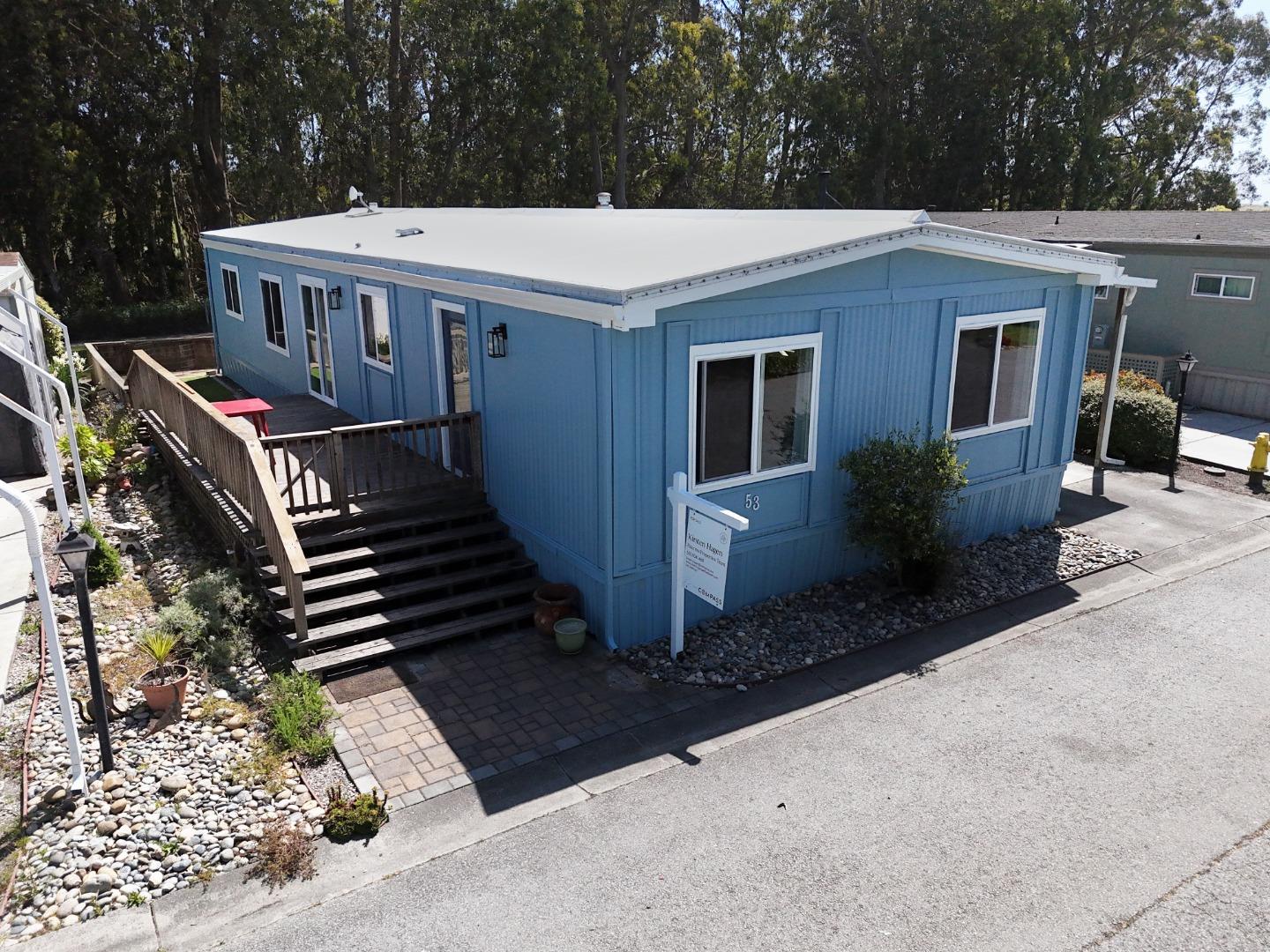 a view of an house with backyard space and balcony