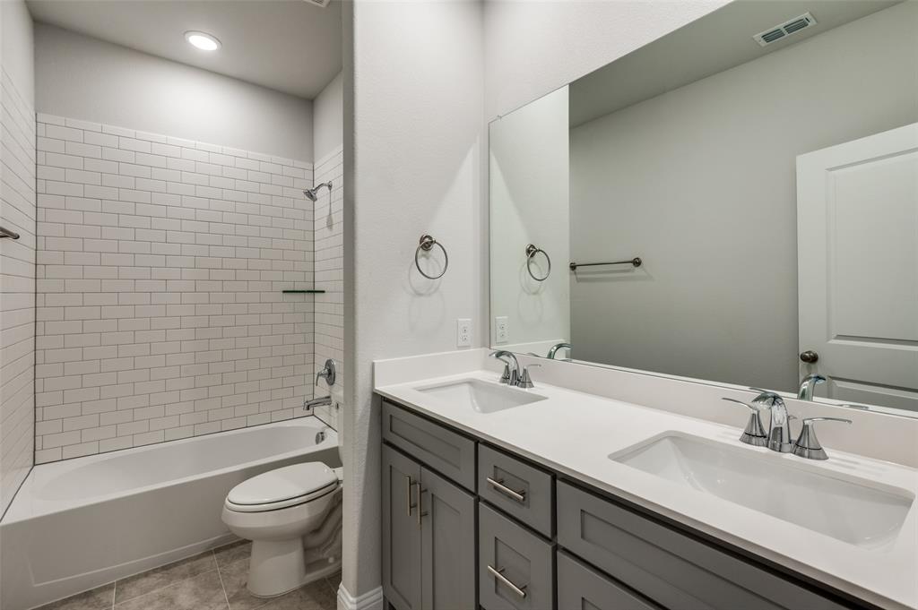 832 Santa Lucia Drive Anna, TX 75409 - Photo 16 of 33 Bathroom with shower / tub combination, double vanity, and light tile patterned floors