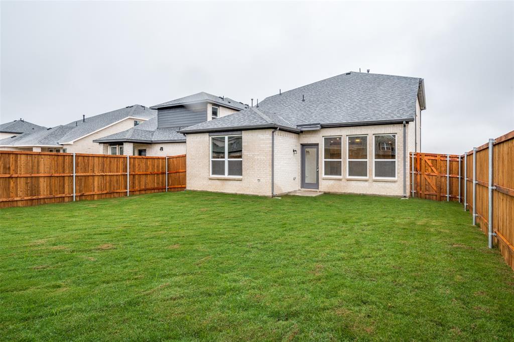 832 Santa Lucia Drive Anna, TX 75409 - Photo 19 of 33 Back of house with a shingled roof, brick siding, and a fenced backyard