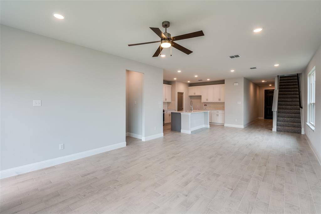 832 Santa Lucia Drive Anna, TX 75409 - Photo 3 of 33 Unfurnished living room with recessed lighting, light wood-type flooring, stairs, and ceiling fan