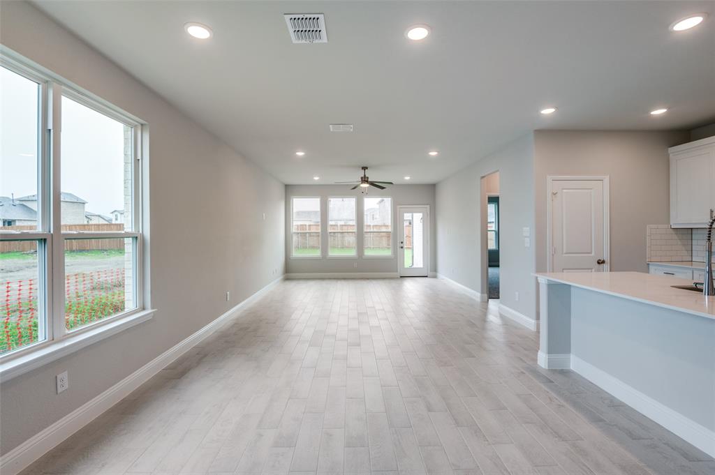 832 Santa Lucia Drive Anna, TX 75409 - Photo 7 of 33 Unfurnished living room with recessed lighting, light wood-style floors, and ceiling fan