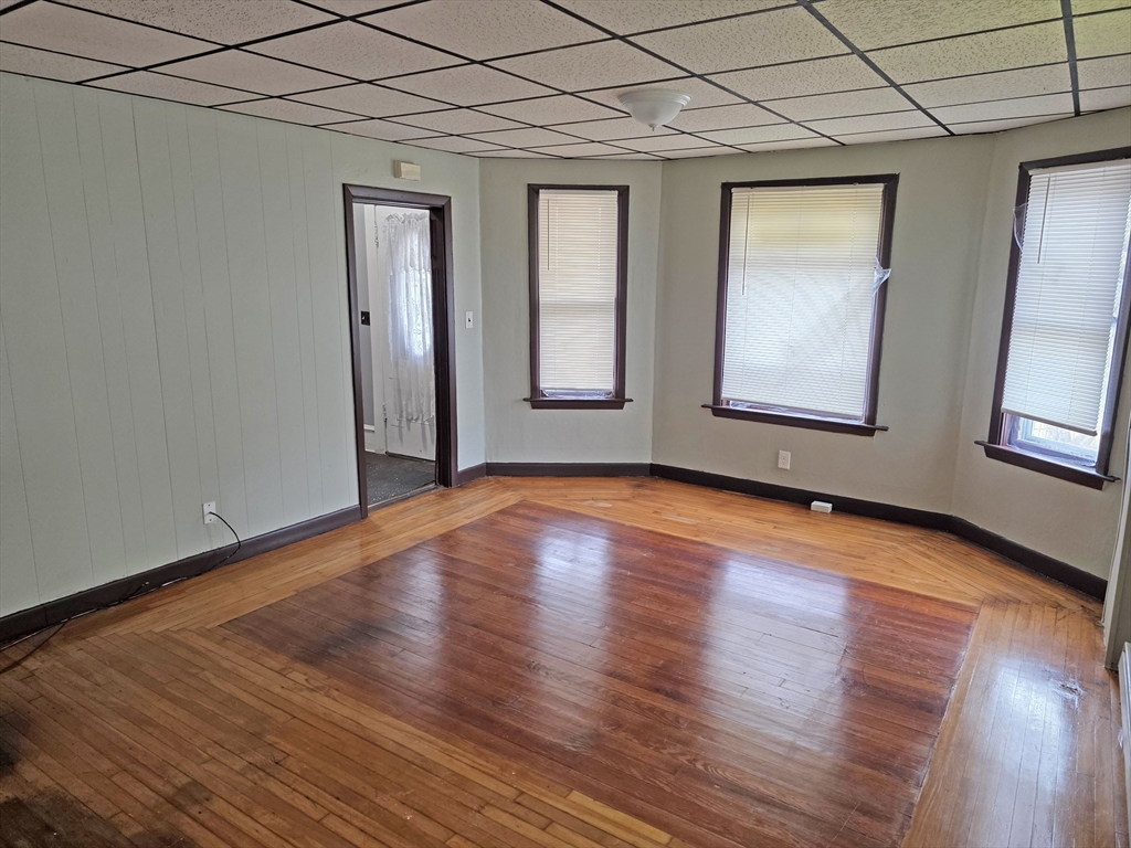 150 Forest Street Fall River, MA 02721 - Photo 5 of 9 an empty room with wooden floor and windows