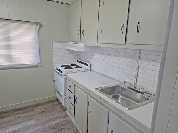 a white toilet sitting next to a bath tub