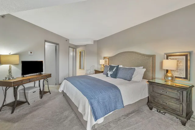 a bedroom with a bed and a flat screen television