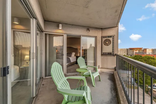 a dining room with furniture and a floor to ceiling window