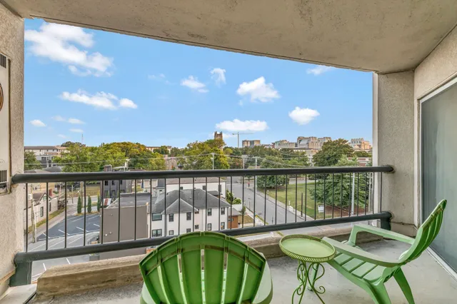 a view of a balcony with lake view and a potted plant