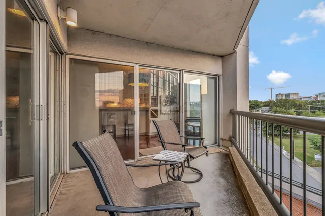 a view of a chairs and table in a balcony