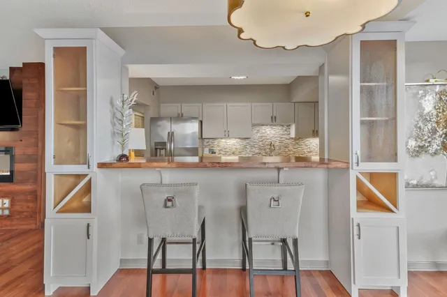 a kitchen with stainless steel appliances granite countertop a refrigerator and microwave