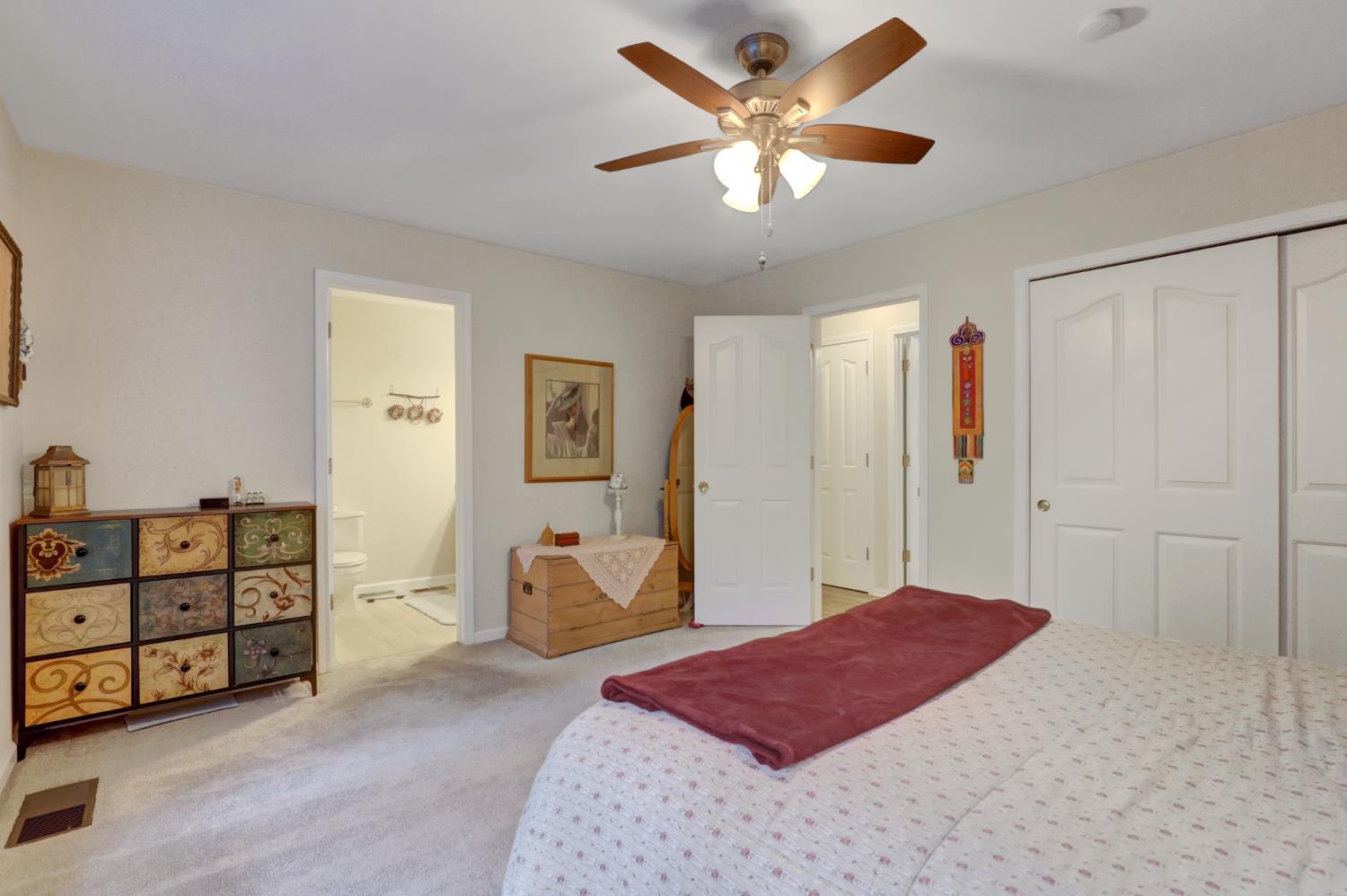 364 Gracie Road Nevada City, CA 95959 - Photo 25 of 59 a spacious bedroom with a bed and a chandelier