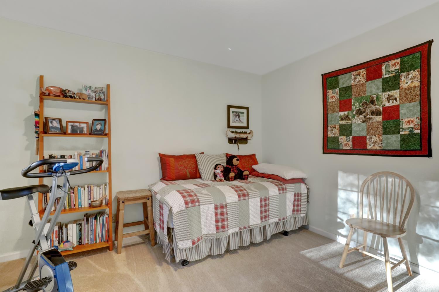 364 Gracie Road Nevada City, CA 95959 - Photo 31 of 59 a bedroom with a bed a dresser and book shelf