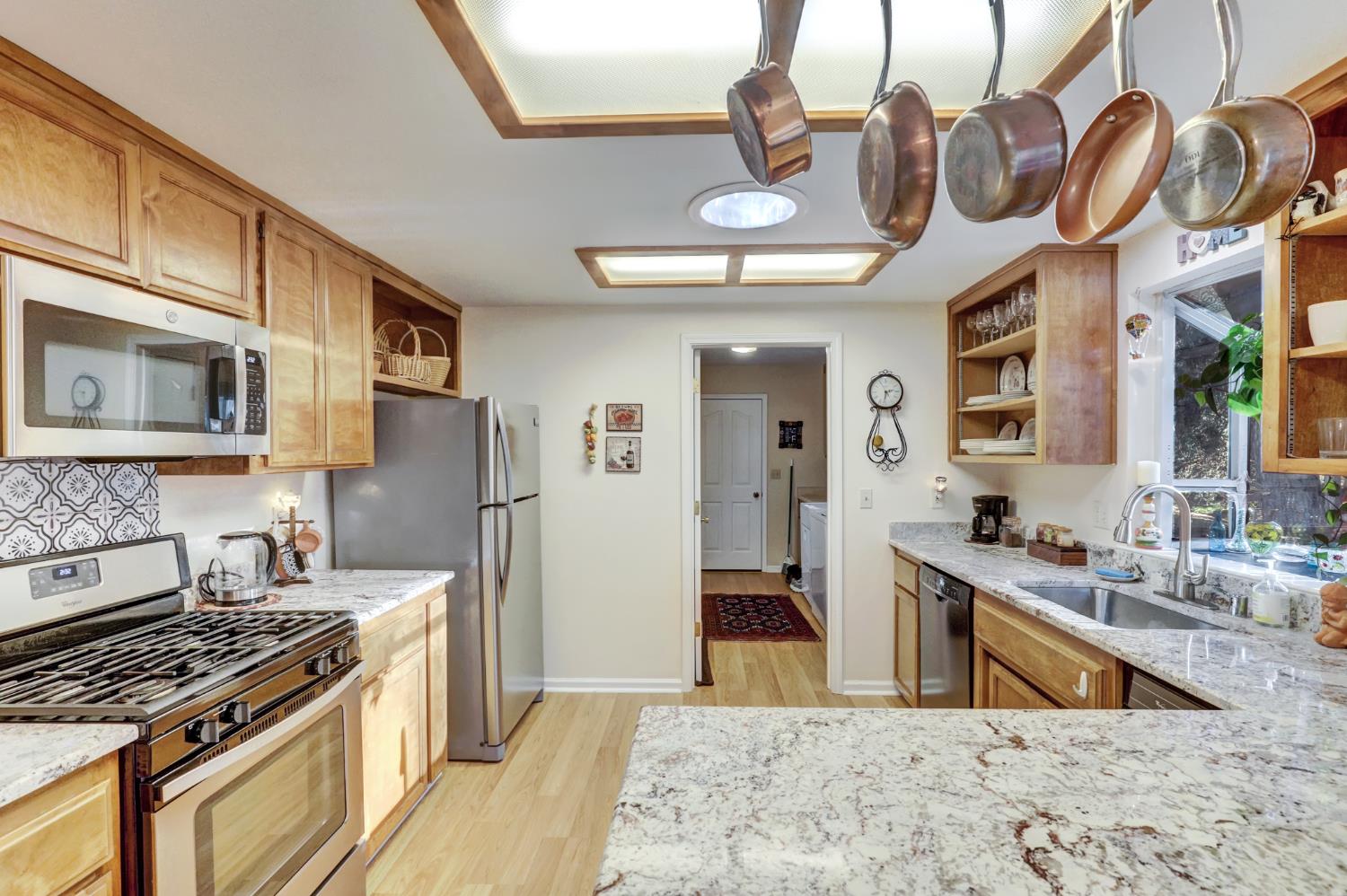 364 Gracie Road Nevada City, CA 95959 - Photo 45 of 59 a kitchen with stainless steel appliances granite countertop a stove and a sink