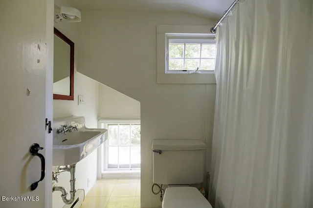a room with a sink cabinets and appliances