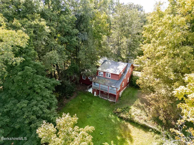 a view of a backyard with sitting area