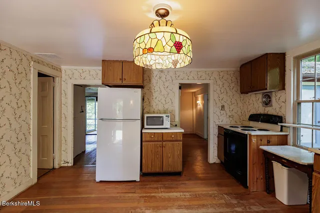 a kitchen with stainless steel appliances granite countertop a refrigerator a stove top oven a sink and dishwasher