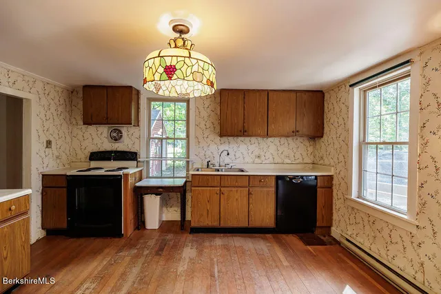 a kitchen with stainless steel appliances granite countertop a stove and a wooden cabinets