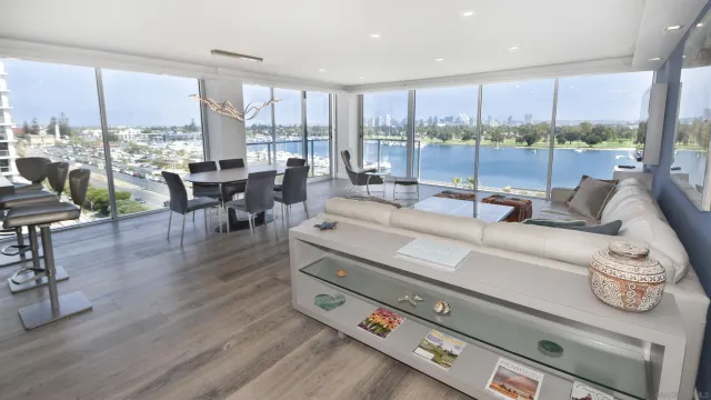 a living room with furniture and a floor to ceiling window