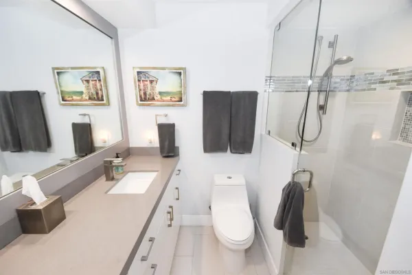 a bathroom with a tub sink and mirror