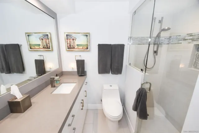 a bathroom with a tub sink and mirror