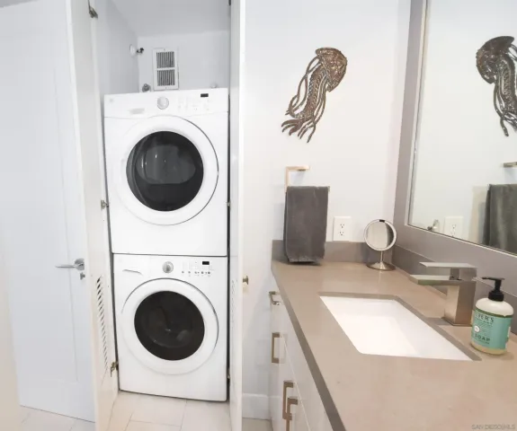 a bathroom with a sink a washer and dryer